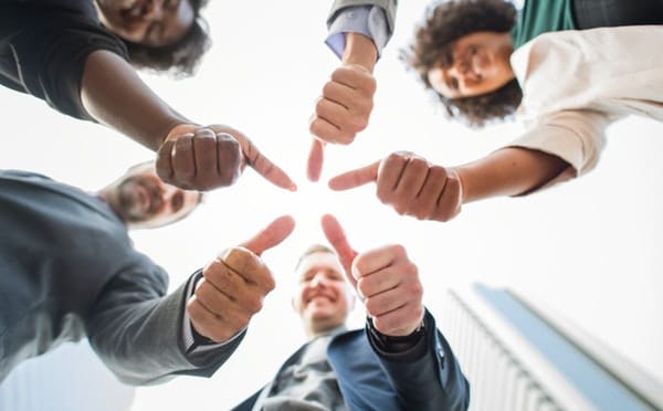 group of people with thumbs up - business simulations are where mistakes are encouraged